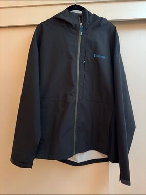 cotopaxi Cielo womens xl Waterproof Hooded Rain Jacket black with blue Logo NWOT